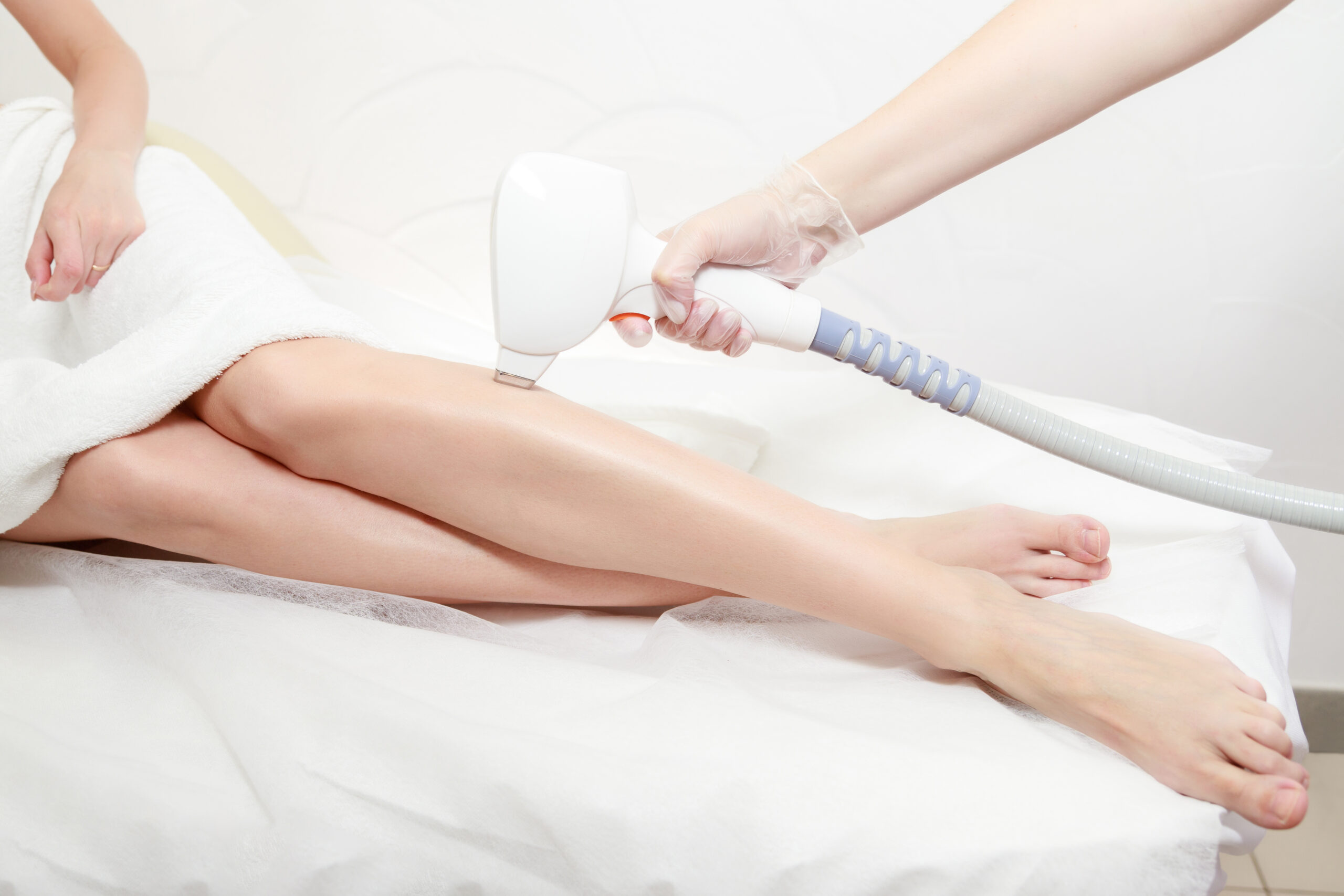 diode laser hair removal of beautiful female legs at the beautician. hair removal on the female body. laser hair removal in a clinic or beauty salon